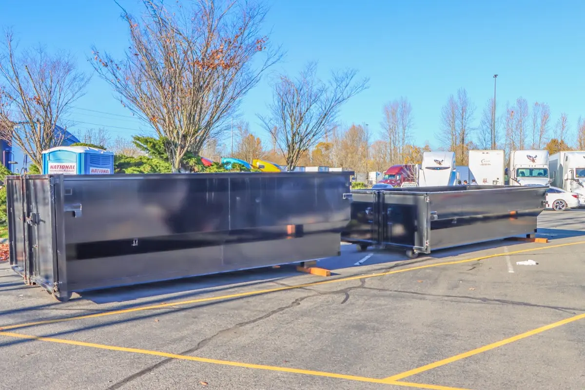 Professional dumpster rental service with roll-off container on residential driveway in St. Martinville